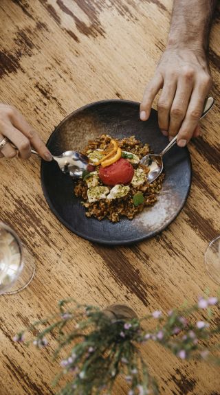 Couple enjoying food and drink at Zecca Restaurant, Griffith